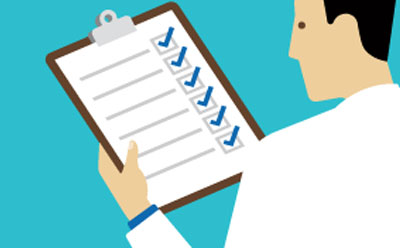 A person in a lab coat looking at a checklist