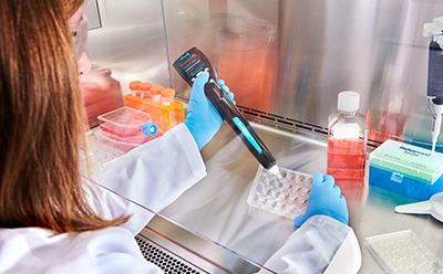 Lab worker using a Scepter™ 3.0 Handheld Cell Counter.