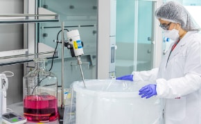 A picture showing an operator manipulating a mixer to perform a hydration protocol for culture media.