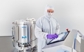 A photo showing an operator manipulating the control system of a single-use mixer.