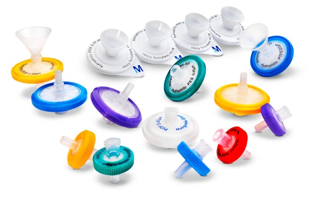 Millex® syringe filters An assortment of Millex<sup>®</sup> syringe filters in various colors and sizes, displayed against a white background. These filters represent a range of small-volume filtration options for laboratory use. The filters come in different colors such as blue, green, yellow, purple, and red, indicating different filter types or pore sizes. Each filter has a circular shape with a conical funnel-like structure on top for attaching to a syringe. The central part of the filters is white with labeling that includes the brand name “Millex®”. Some filters have a transparent top section while others are opaque. There is also one funnel accessory included in the image which is used to assist with pouring liquids into the filter. These filters set the standard in small-volume filtration (1-200 mL), and their unsurpassed consistency in sample preparation has led to the development of many methods specifying their use.