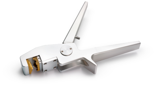 Metal tool on white background with a space at one end where tubing should be placed.  Tool designed for manual use with gloved hands.