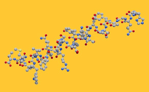 The image depicts a complex molecular structure with variously colored atoms linked by bonds, set against a yellow background.