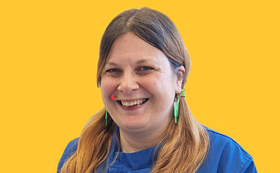 Rae Freestone headshot on a vibrant yellow background