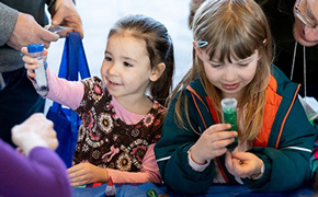 Discovery World girl holding flask