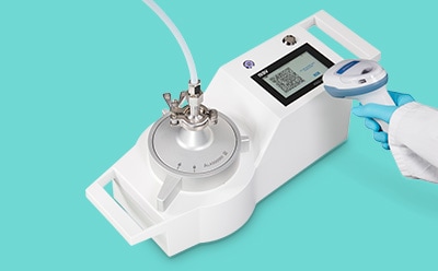 Operator scanning a barcode on the display of the MAS-100 Atmos<sup>®</sup> microbial gas sampler