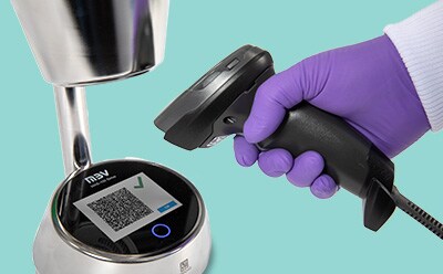 Hand with gloves holding a scanner pointing at the a result barcode on the display of the MAS-100 Sirius<sup>®</sup> microbial air sampler