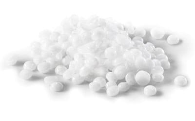 Colorless or white pellets of a caustic base sodium hydroxide/potassium hydroxide